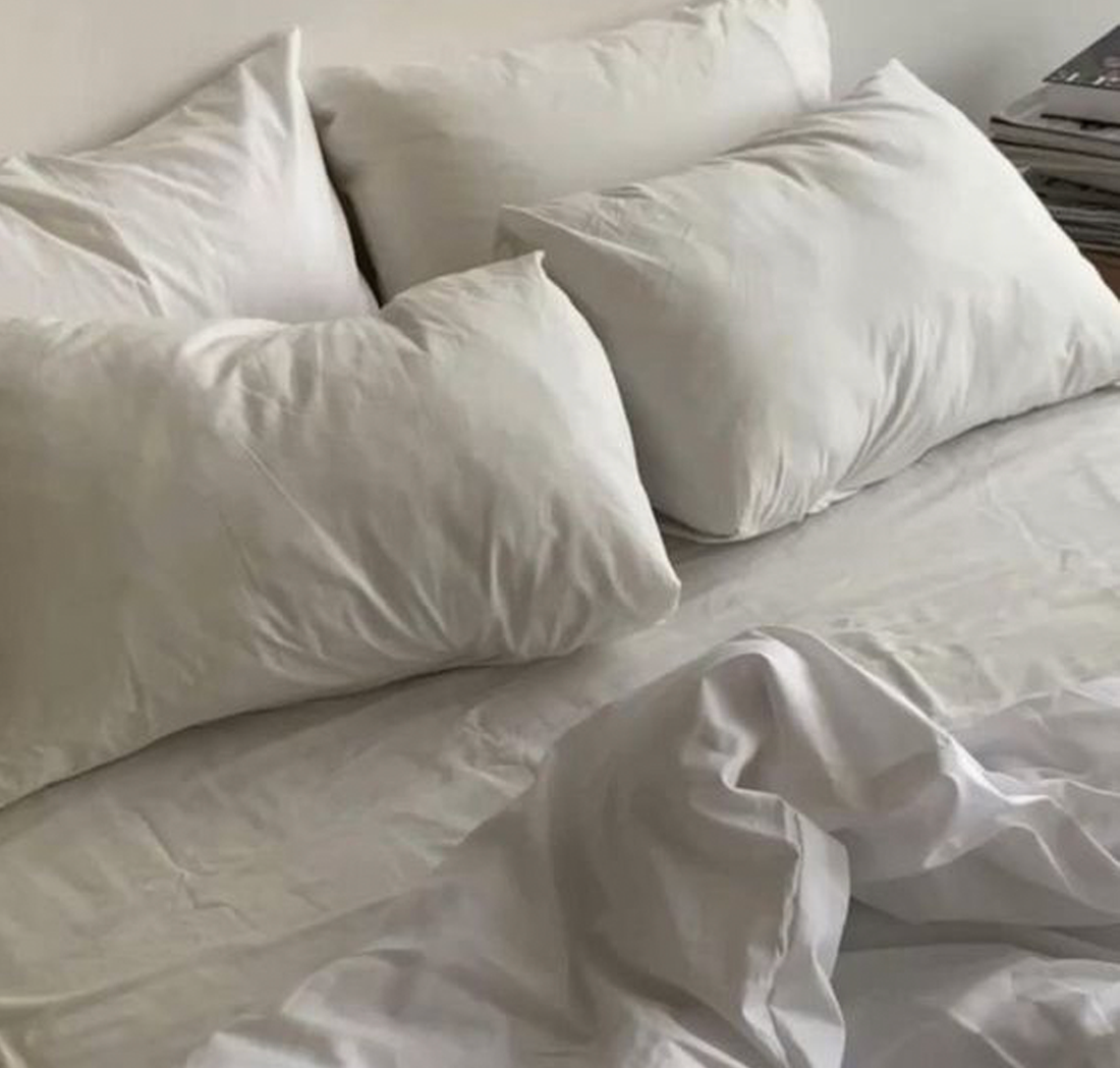 A clean white bed 